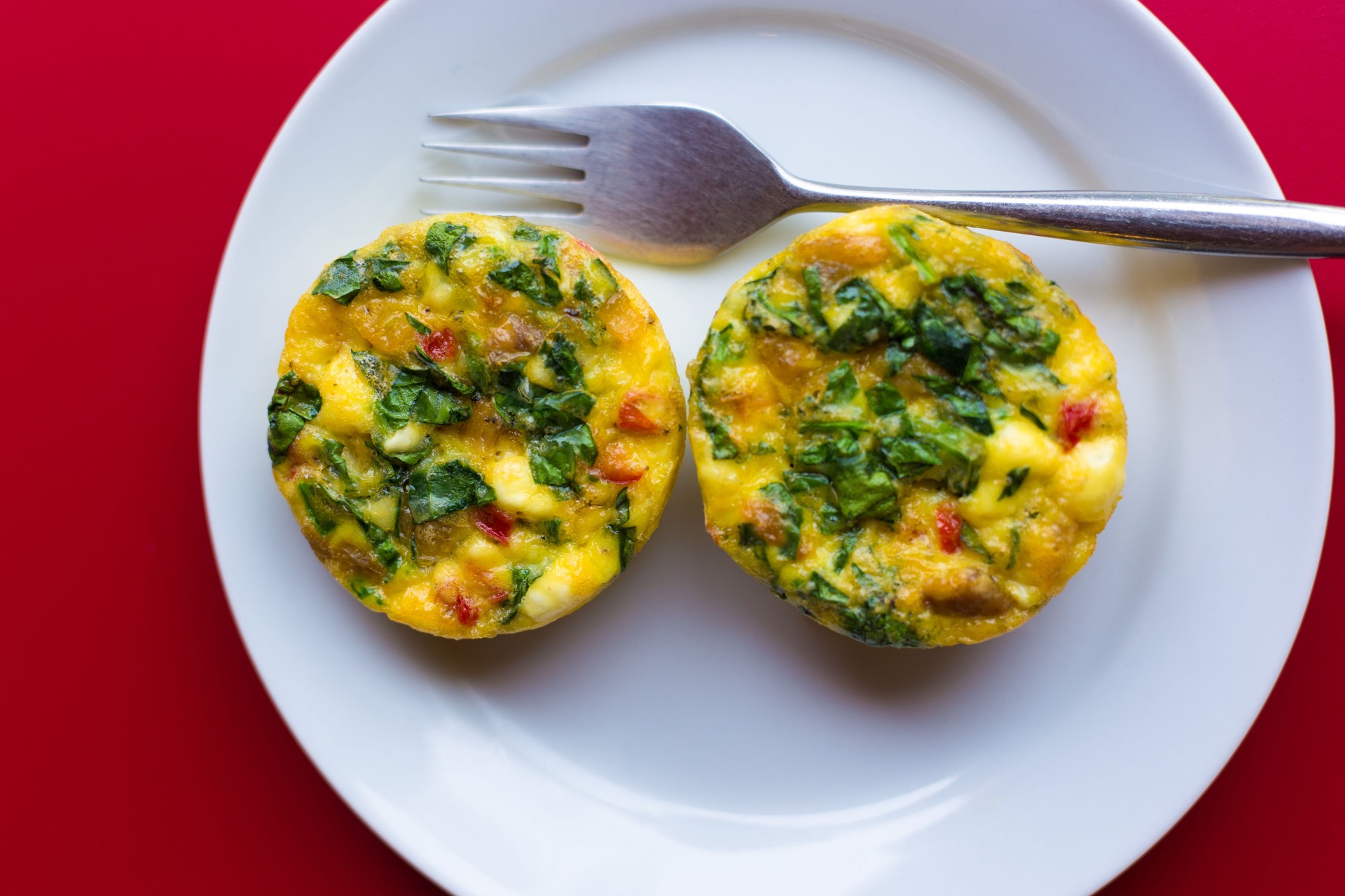 Mini-Quiche Lorraine on White Plate, Red Background